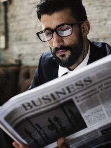 Businessman reading newspaper