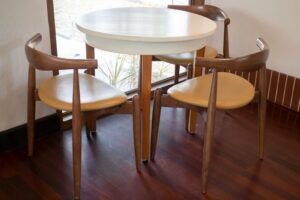 Mesa redonda e cadeiras de madeira, ilustrando um dos tipos de mesa para cada ocasião